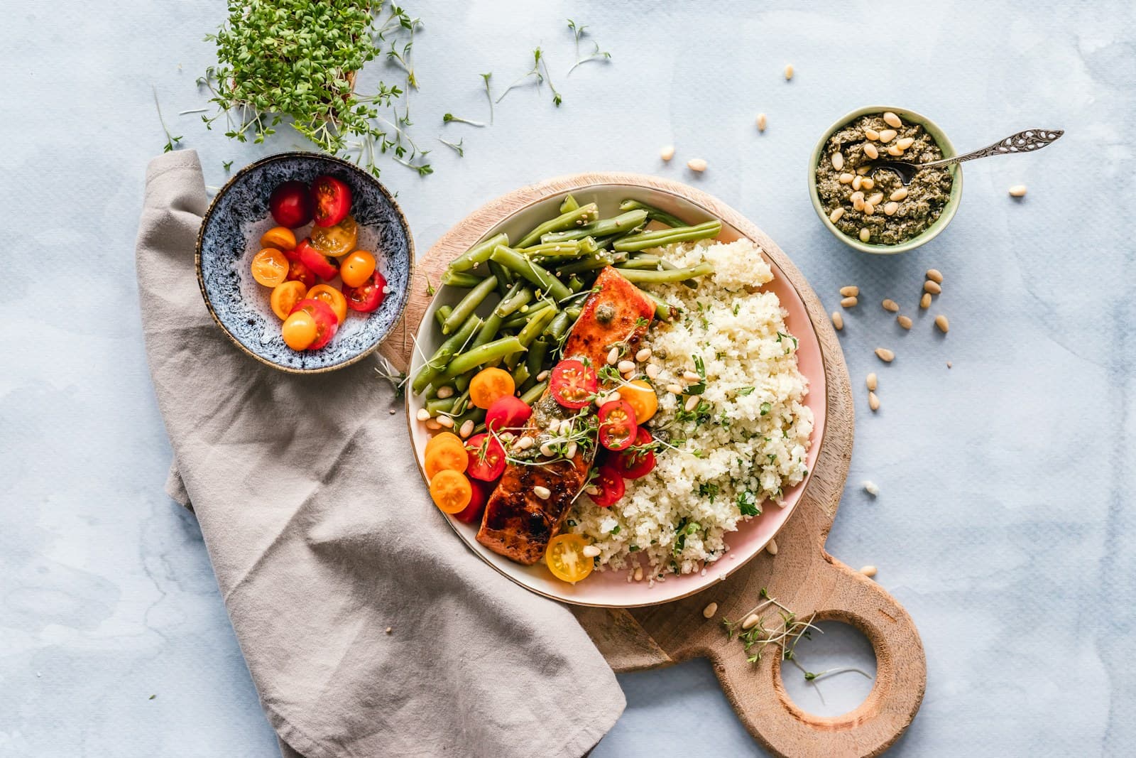 A bright homemade dinner bowl with salmon, couscous, and green beans